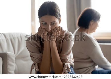 Offended millennial 30s adult daughter and senior mom sit aside back to back avoid talking after quarrel, mother and grown up daughter toxic relations, spoiled relationships, generational gap concept Royalty-Free Stock Photo #2378432627