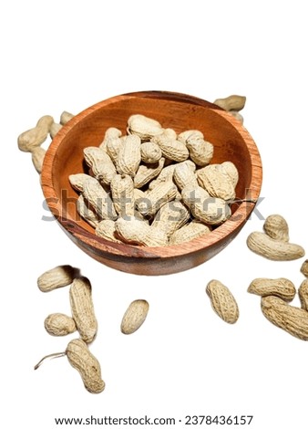 Group of peanuts isolated on white, peanuts in a wooden bowl for eating while watching together