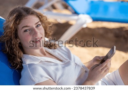 Relaxing Portrait of Young Woman Using Smartphone for Leisurely Communication.