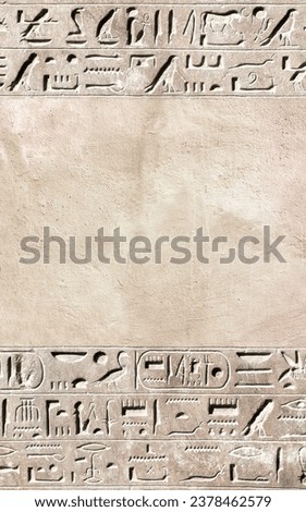 Vertical background with ancient Egyptian hieroglyphs on stone wall, Egypt, Africa. Backdrop with sandstone carving with hieroglyph. Mock up template. Copy space for text Royalty-Free Stock Photo #2378462579