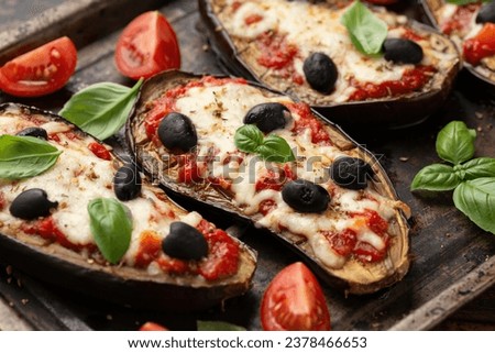 Healthy Eggplant or Aubergine pizza with tomato sauce, mozzarella cheese, basil and olives Royalty-Free Stock Photo #2378466653