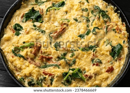 Creamy spaghetti squash pasta with parmesan cheese and sun dried tomato sauce in iron cast pan Royalty-Free Stock Photo #2378466669