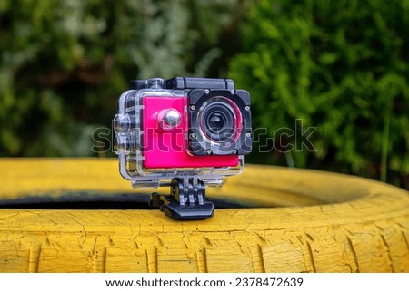 Action camera in a protective box for shooting dynamic videos.