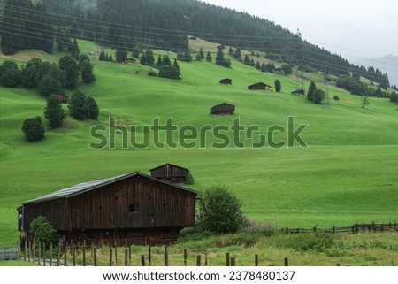 Typical barns for Tyrol Germany scattered along the mountain sides, picture from the small village of Gerlos.