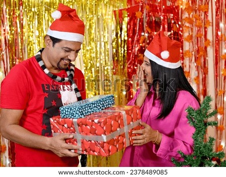 Happy couple celebrating Christmas at home.
