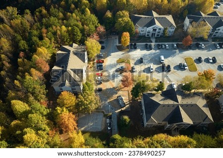 Aerial view of new apartment houses between yellow trees in South Carolina suburban area in fall season. Real estate development in american suburbs Royalty-Free Stock Photo #2378490257