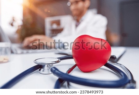Stethoscope and red heart on wooden table. Cardiology concept Royalty-Free Stock Photo #2378493973