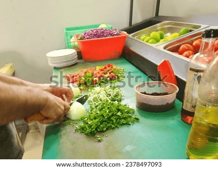 Tomato salad making to serve as a sidebar with liver-kebap Royalty-Free Stock Photo #2378497093