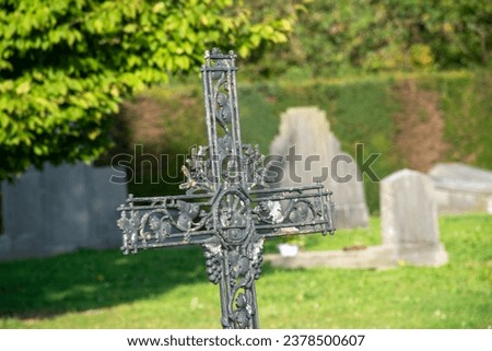 metal cross on the old cemetery, cross against the background of green nature, All Souls' Day, church tradition