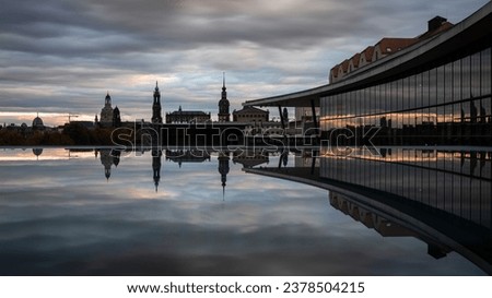 The famous skyline of the old town of Dresden as seen from the Dresden Congress Center with a reflection in a puddle on the roof terrace.