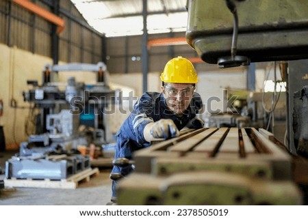 Lathe Operators Concentrated on Work. Worker in uniform and helmet works on lathe, factory. Industrial production, metalwork engineering, manufacturing.