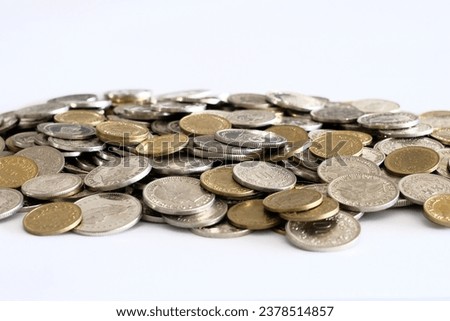 A pile of Swiss Franc (CHF) coins to showcase the increasing cost of living and the reducing amount of savings and earnings