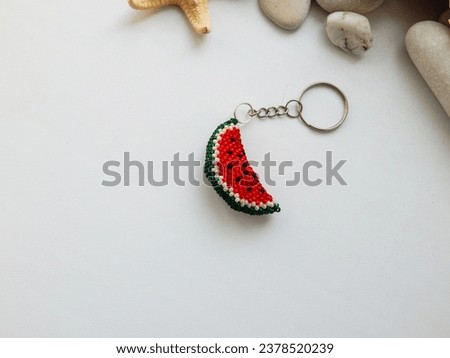 Decorative red fruit key chain accessory on a chain