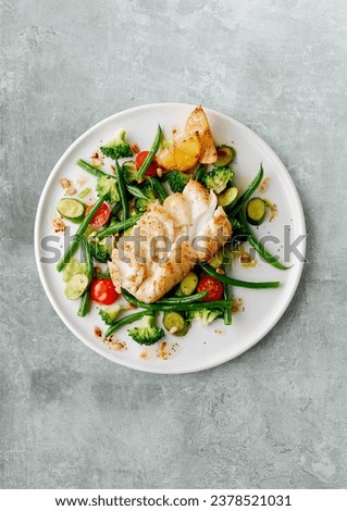 Fried cod fish fillet with lettuce and vegetable