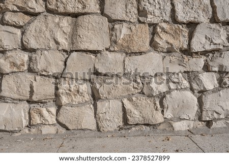 Wall of white rocks joined with cement.