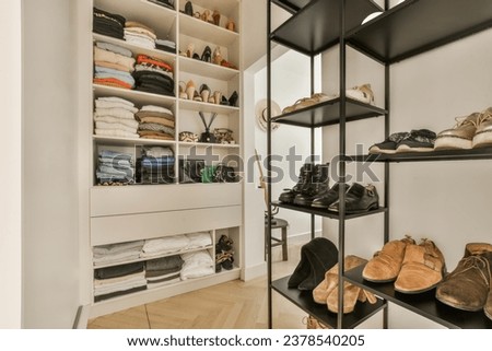 the inside of a walk - in closet with shoes and other items on shelves, as well as they do Royalty-Free Stock Photo #2378540205