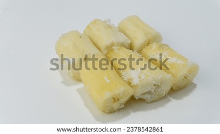 Singkong rebus or Boiled cassava accompanied by a sprinkling of grated coconut isolated on a white background