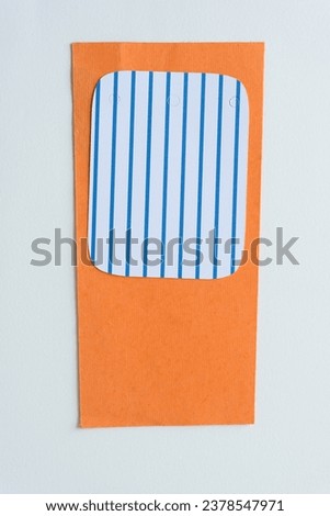 striped paper shape on orange and blank paper