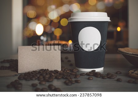 Photo blank paper cup of coffee and business card coffee shop to apply logo