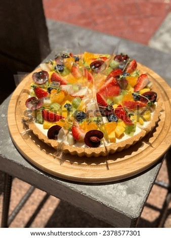 Lemon Meringue Tart is tangy and sweet. Dessert on a white plate. Free space for text. Yellow flower and mixed berry topping. Menu cafe and coffee shop