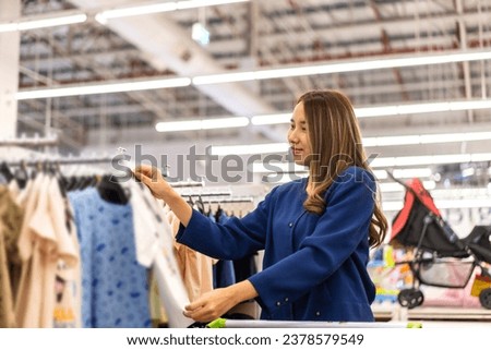 Portrait of mother relax and enjoy shopping time walk to buy something purchases and choosing baby and children clothes in a kid store shop.fashion kid shopping concept
