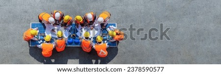 Top view architect engineer working on solar panel and his blueprints with solar photovoltaic panels system and wind turbine on construction site. clean energy concept. copy space for text and design Royalty-Free Stock Photo #2378590577