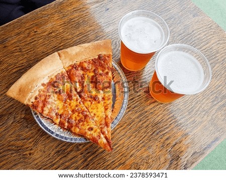 Slice of pizza and beer on the table