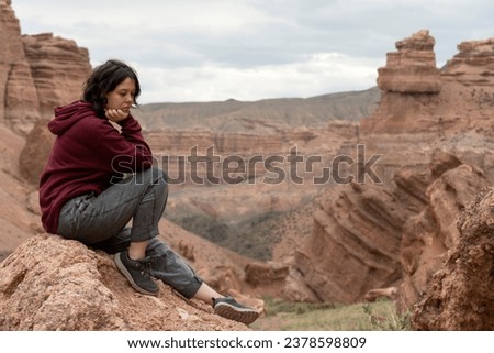 A young woman sightseeing  in the Central Asian Canyon, Charyn, Kazakhstan