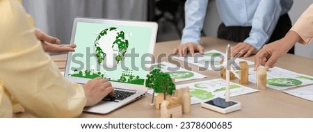 Green city logo displayed on a laptop at a green business meeting. Team presenting green design to customer. ESG environment social governance and Eco conservative concept. Closeup. Delineation.