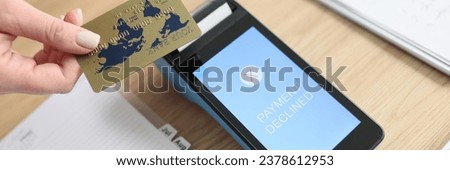 Woman fails paying for services with credit card via terminal. Payment Declined on screen of banking equipment on wooden table in office Royalty-Free Stock Photo #2378612953