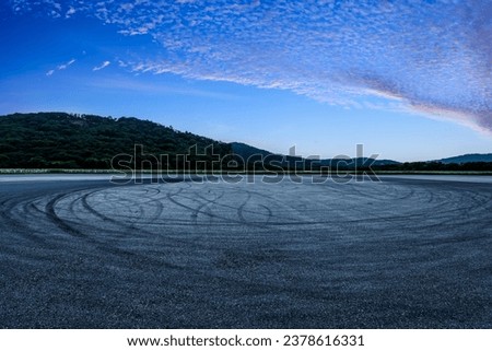 Race track road and mountain with sky clouds at sunset