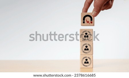 Businessman hold and put wooden cube block shape, Inbound marketing strategy, Wooden cubes with magnet icon attracts the customer icons.customer retention, digital marketing and attracting potential. Royalty-Free Stock Photo #2378616685