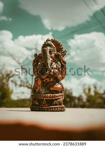 Capture the divine beauty of Lord Ganesha amidst a mesmerizing backdrop of clouds. This enchanting photo showcases the peaceful and majestic presence of Lord Ganesha, with his iconic image radiating s