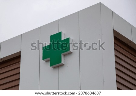 cross green lighting logo sign on wall building shop pharmacy facade