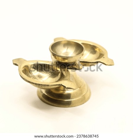a unique three head antique aarti lamp made of gold brass used for traditional ceremonies and festivals isolated in a white background