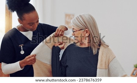 Senior woman, nurse and help with clothes, smile and care in retirement, nursing home and support. African caregiver, elderly lady and happy with getting dressed with assisted living, love and house Royalty-Free Stock Photo #2378676359