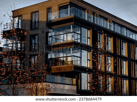 European modern residential apartment buildings complex condo real estate. Glass balcony. Dark brick. Real house in Tallinn, Estonia. Sky background. High quality photo