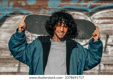 teenager boy with skateboard on the street Royalty-Free Stock Photo #2378691717