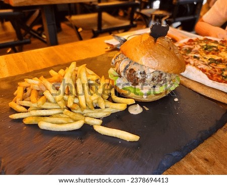 Burger with french fried in close up view