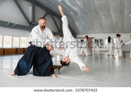 Aikido teacher and student training throwing and falling Royalty-Free Stock Photo #2378707433