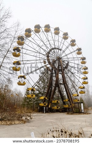 Ferris wheel in abandoned amusement park in ghost town Pripyat, Ukraine. Chornobyl exclusion zone Royalty-Free Stock Photo #2378708195