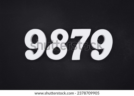 Black for the background. The number 9879 is made of white painted wood.