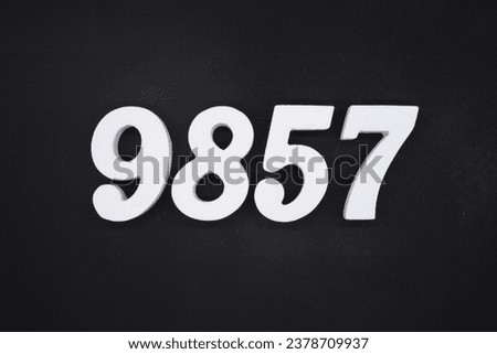 Black for the background. The number 9857 is made of white painted wood.