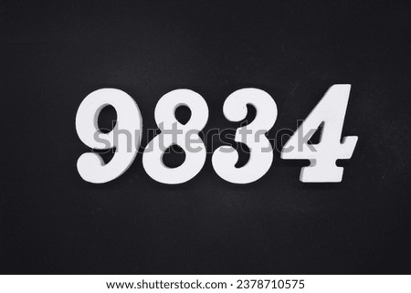 Black for the background. The number 9834 is made of white painted wood.