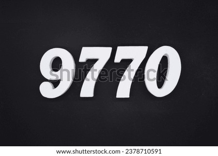 Black for the background. The number 9770 is made of white painted wood.