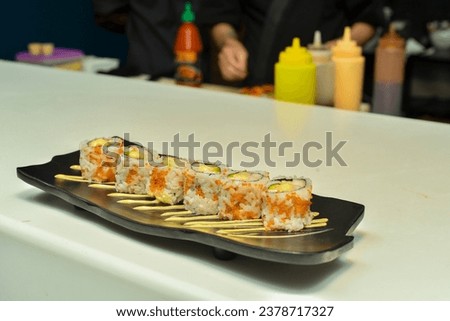 Picture of sushi veggie roll served on a black plate