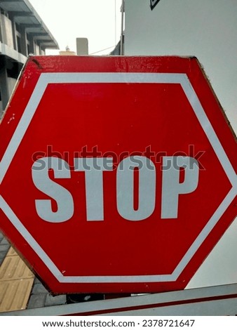 Red stop sign in front of an office.