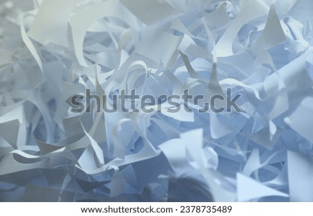 Shredded paper texture background, top view of many white paper strips. Pile of cut paper like confetti for party or box filler for shipping fragile items