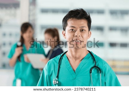 Asian Medical team of doctors and nurses standing in a hospital.