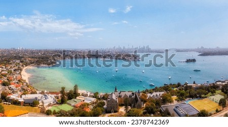 Rose bay beach of eastern suburbs on the South head of Sydney harbour - aerial panorama to city CBD skyline.